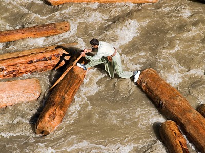 Sending logs down the river for timber is a dangerous trade, several men die each year along the Chitral River